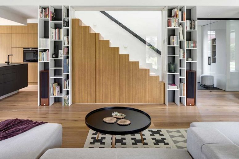 The minimalist staircase features some hidden storage units for more functionality