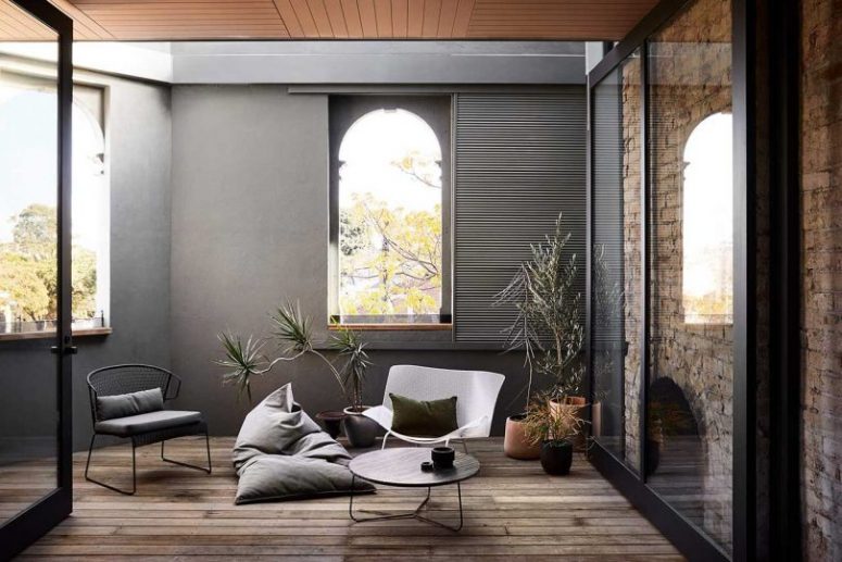This small lounge features comfy sitting furniture, much natural light and potted plants