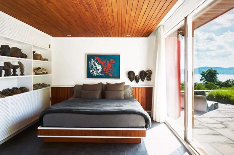 The master bedroom is decorated with tiles and stained wood, with cool furniture and lots of decor items from various travels