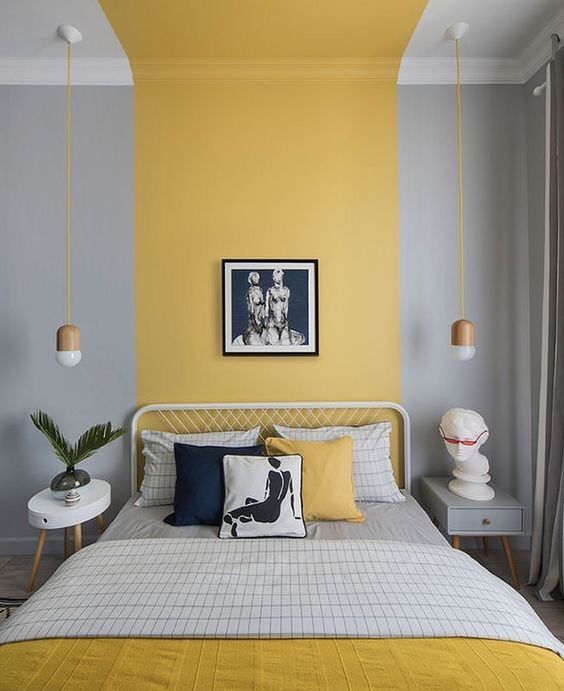 a contemporary bedroom with color block dove grey and yellow walls, white and grey furniture, grey and yellow bedding and pendant lamps