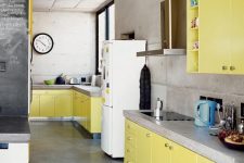 a minimalist light yellow kitchen with concrete countertops and walls is a simple and bright space that looks contrasting