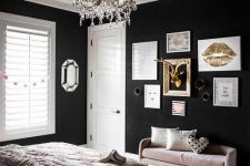 a modern glam bedroom with black walls, a floral ceiling, blush and black bedding and a chic gallery wall