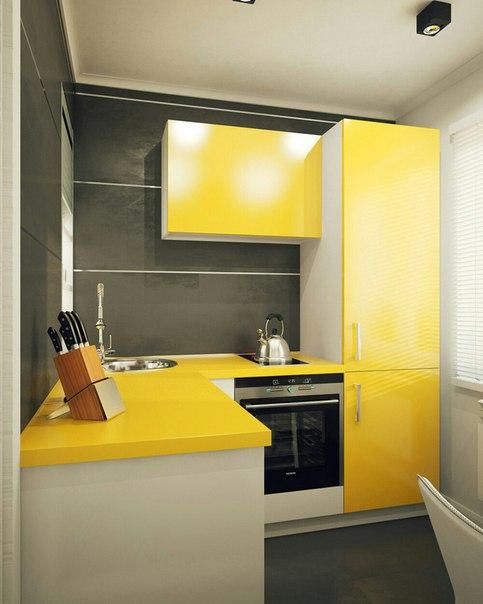 a small minimalist kitchen with bright yellow cabinets and graphite grey walls plus white touches to refresh the space