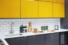 a stylish minimalist kitchen with sleek grey and sunny yellow cabinets, a white subway tile backsplash to refresh the space