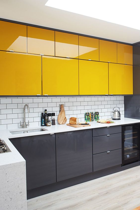 a stylish minimalist kitchen with sleek grey and sunny yellow cabinets, a white subway tile backsplash to refresh the space