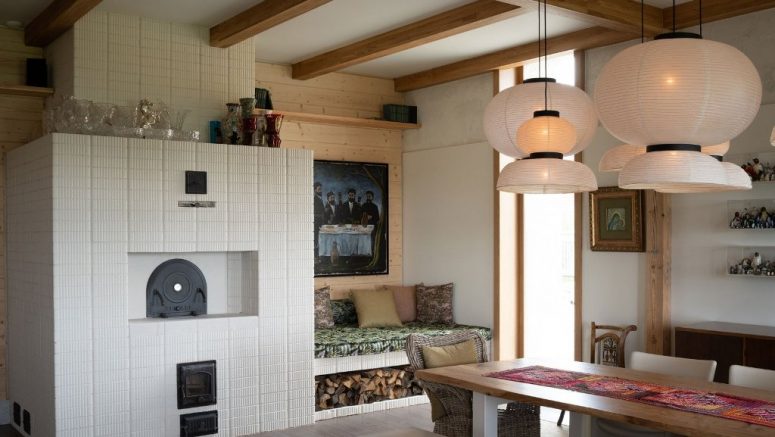 The kitchen is done in neutrals but with bright textiles and a hearth with a seat is the coziest nook