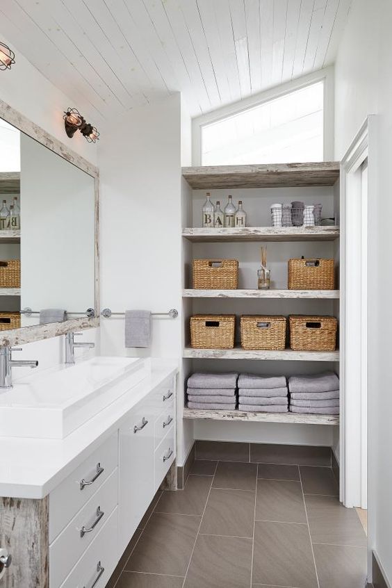 a neutral shabby chic bathroom with shabby chic open shelves on one side that give plenty of storage space