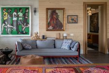 04 The living room shows off bright traditional textiles and neutral furniture plus bold artworks