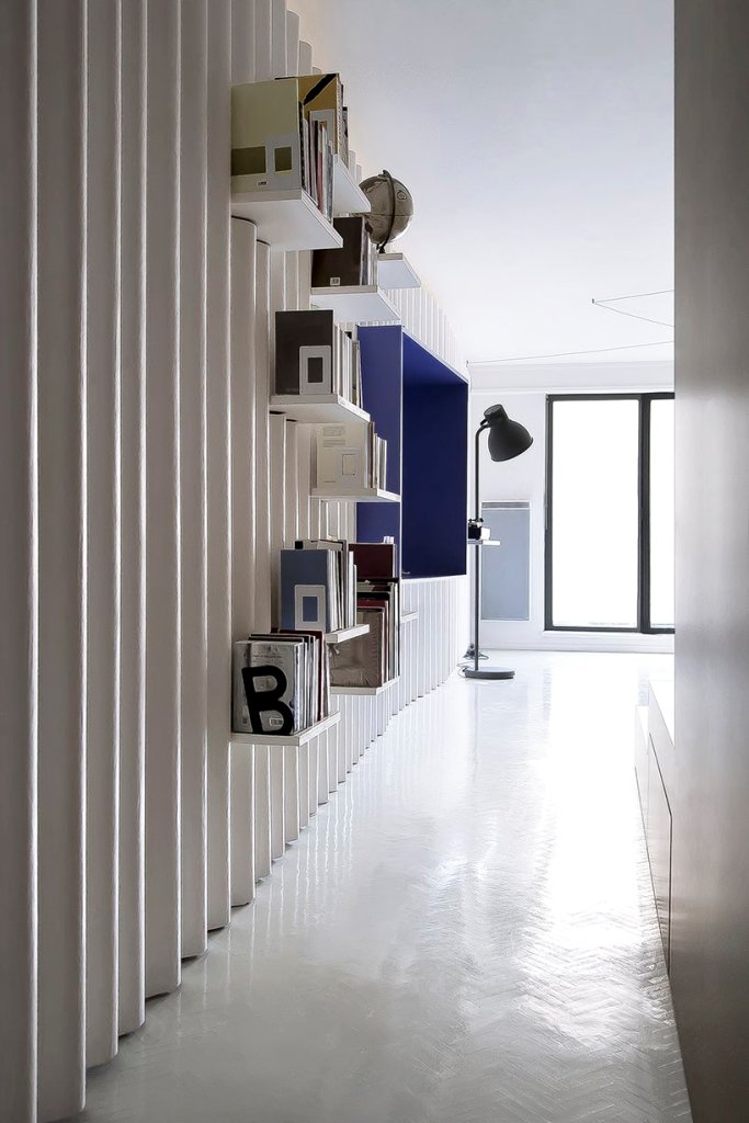 The storage is kept rather open, with many shelves and a large box shelf on the wall