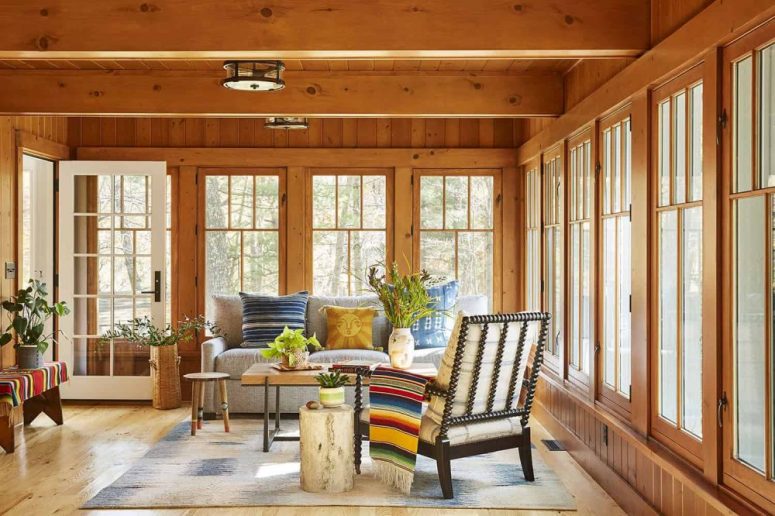 The sunroom is bright and fun, with bold textiles and lots of potted plants