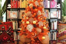 04 a beautiful fall tree in orange, with pinecones, citrus, oversized acorns and ornaments is very unusual