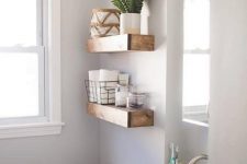 04 thick wooden open shelves over the toilet give a strong rustic feel to the space