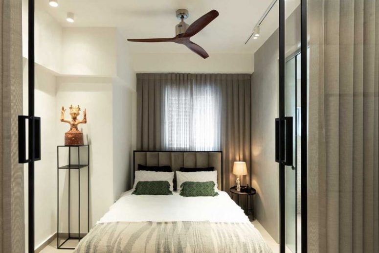 There's a small bedroom hidden behind glass doors, with a comfy bed and almost nothing else