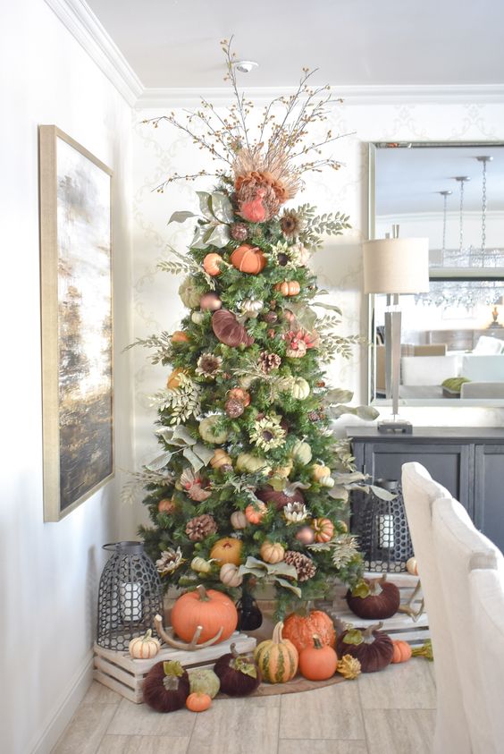 a bright and natural-looking Thanksgiving tree with various pumpkins, pinecones, faux flowers and branches
