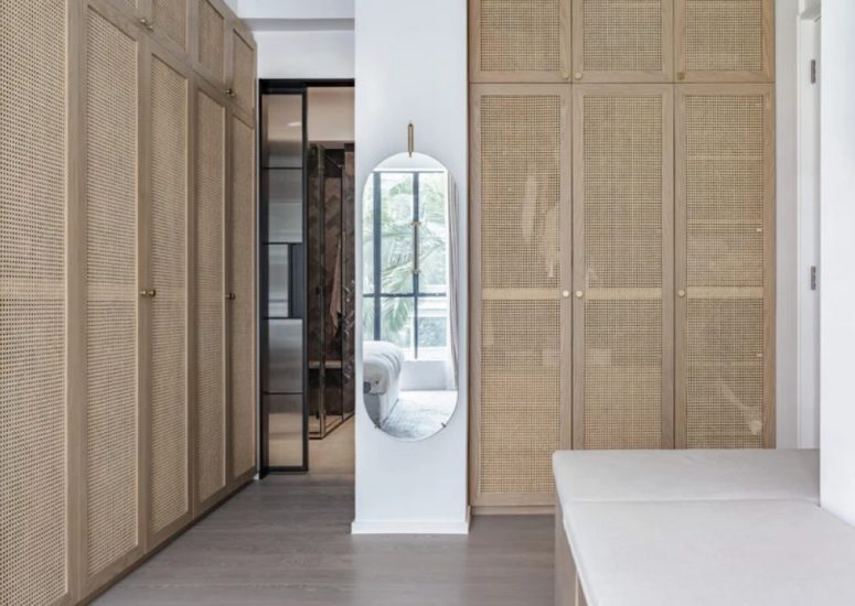 There's a closet with rattan storage units