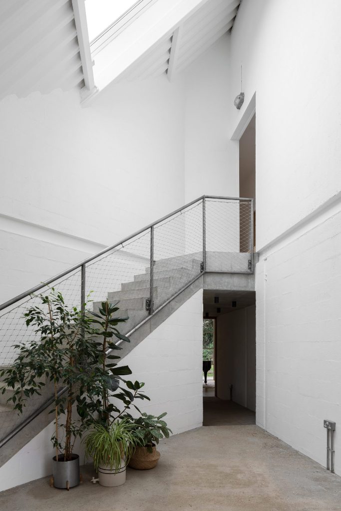 There's an industrial staircase of concrete and metal and some seel on the ceiling here