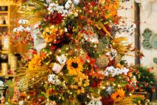 06 a bright fall to Thanksgiving tree with lights, cotton, faux blooms, greenery and branches plus pinecones is wow