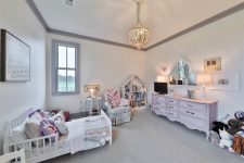 07 The kid’s room is soft and pastel, with chic vintage furniture and a beautiful blush sideboard