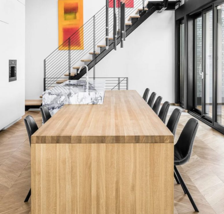 The kitchen island shows off a dining zone attached to it, and you may see an outdoor dining space, too