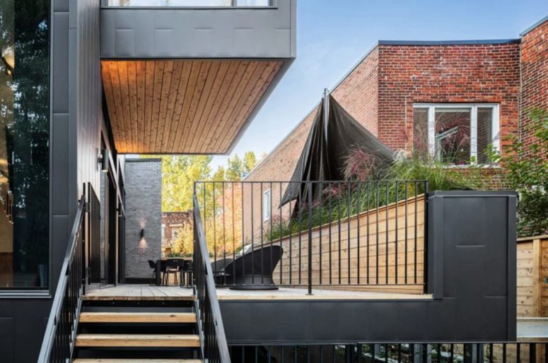 This is a roofed terrace outdoors, with a dining space and some comfy chairs
