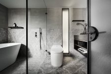 09 The bathroom is done in grey, with white appliances and black touches