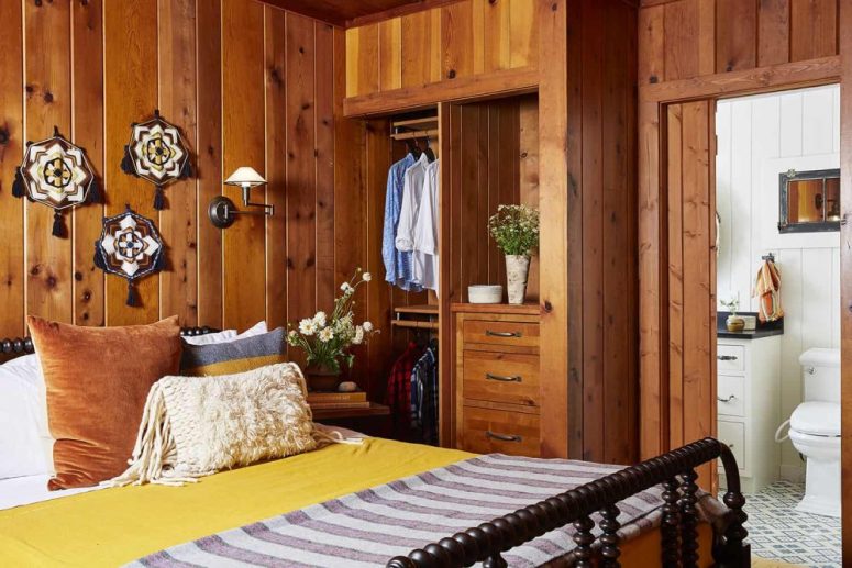 The master bedroom continues the decor of the rest of the house with stained wood and heavy furniture