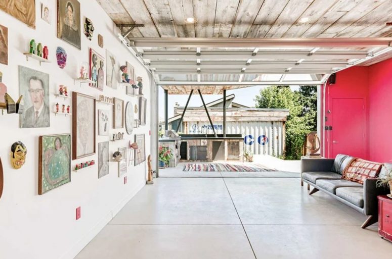 This living room is very bold with its half done in pink, a bold gallery wall and an access to the outdoor kitchen