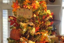 11 a creative vintage-inspired Thanksgiving tree with lights, faux leaves, pumpkins, signs, paper pumpkins