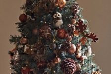 13 a fabulous fall tree decorated with gold and brown ornaments, plywood leaves, pinecones, lights and faux owls