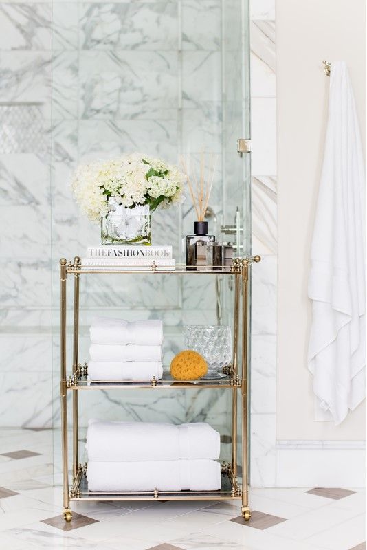 a refined gold and glass rolling cart is a gorgeous option for a sophisticated and chic bathroom