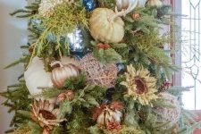 16 a gorgeous fall or Thanksgiving tree with large faux and velvet pumpkins, blooms, lights and metallic yarn balls