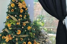 18 a stylish rustic Thanksgiving tree decorated with gold mesh ribbons, faux sunflowers, bright greenery and gold ornaments