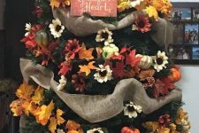 20 a stylish Thanksgiving tree with burlap ribbons, bright faux blooms and leaves and a chic sign