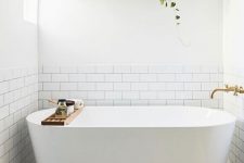 22 a contemporary neutral bathroom with an open floating shelf over the tub to store and display some decor