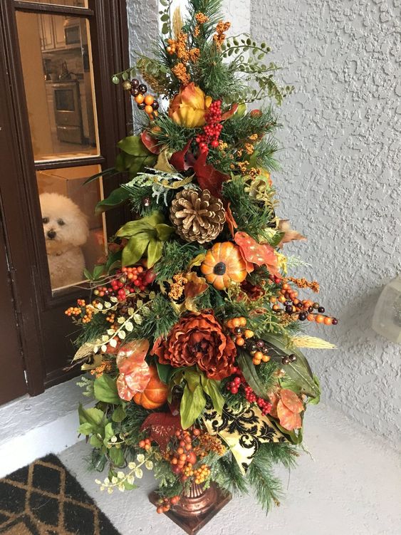 a fall tree with leaves, greenery, berries, bright blooms is a great outdoor decoration for Thanksgiving