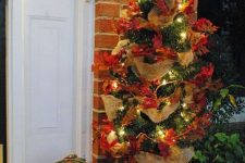 24 a simple fall or Thanksgiving tree decorated with faux leaves, burlap ribbons and lights is a stylish outdoor decoration