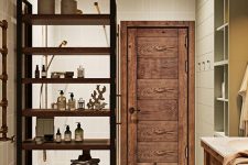 26 a comfortable stained wood shelving unit that divides this bathroom into zones is a very practical thing