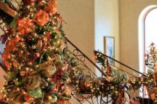 26 a vintage-inspired fall or Thanksgiving tree decorated with orange ribbons, lights green sheer fabric, faux berries and branches