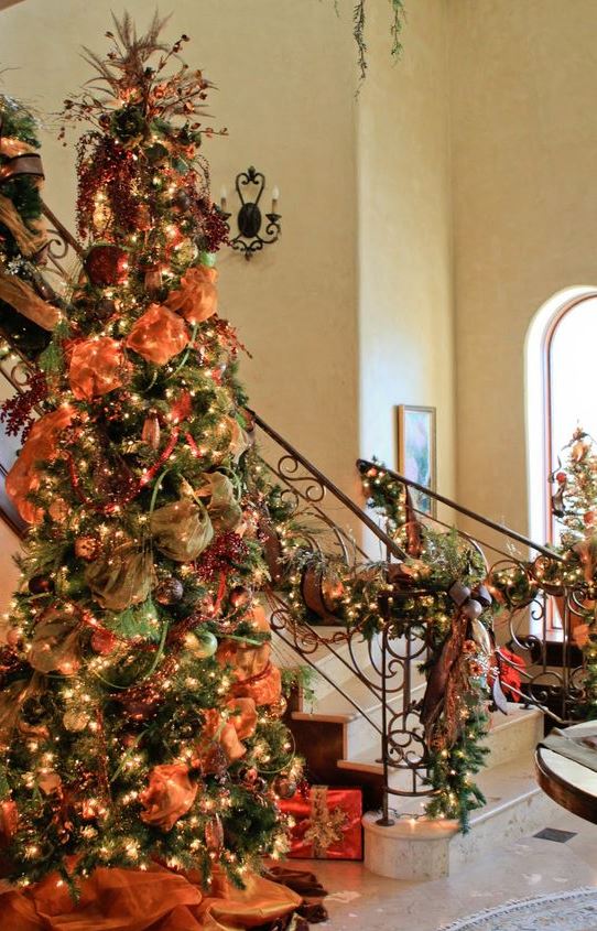 a vintage-inspired fall or Thanksgiving tree decorated with orange ribbons, lights green sheer fabric, faux berries and branches