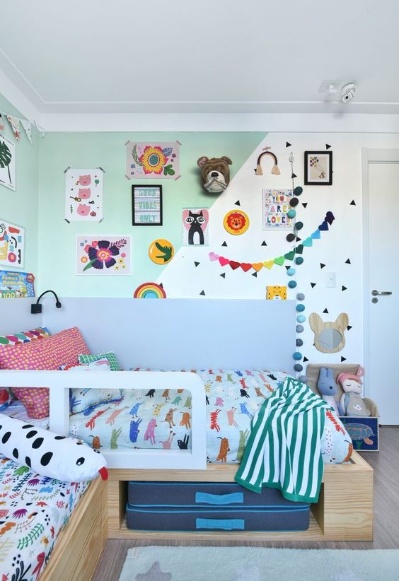 a colorful and fun kid's room with a color block wall, bright decor and garlands, colorful bedding and linens and bold toys