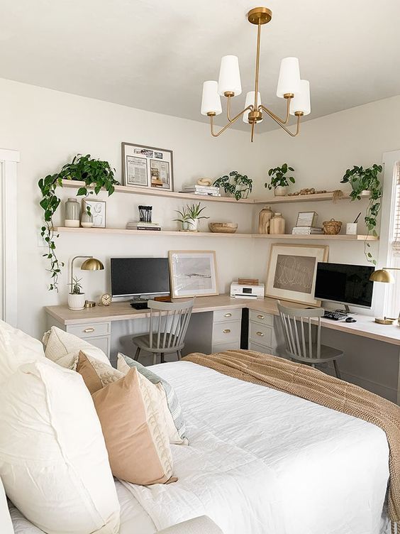 a lovely boho bedroom with a double working space, an L-shaped desk, grey chairs and corner shelves is amazing
