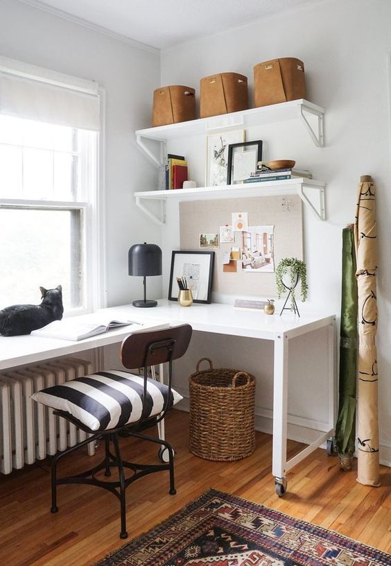 a stylish mid-century modern home office with a white corner desk, a black industrial chair and open shelves is chic