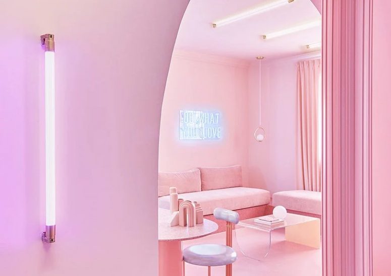 The apartment looks beautiful, with many soft and candy shades of blush and pink, with neon lamps and signs