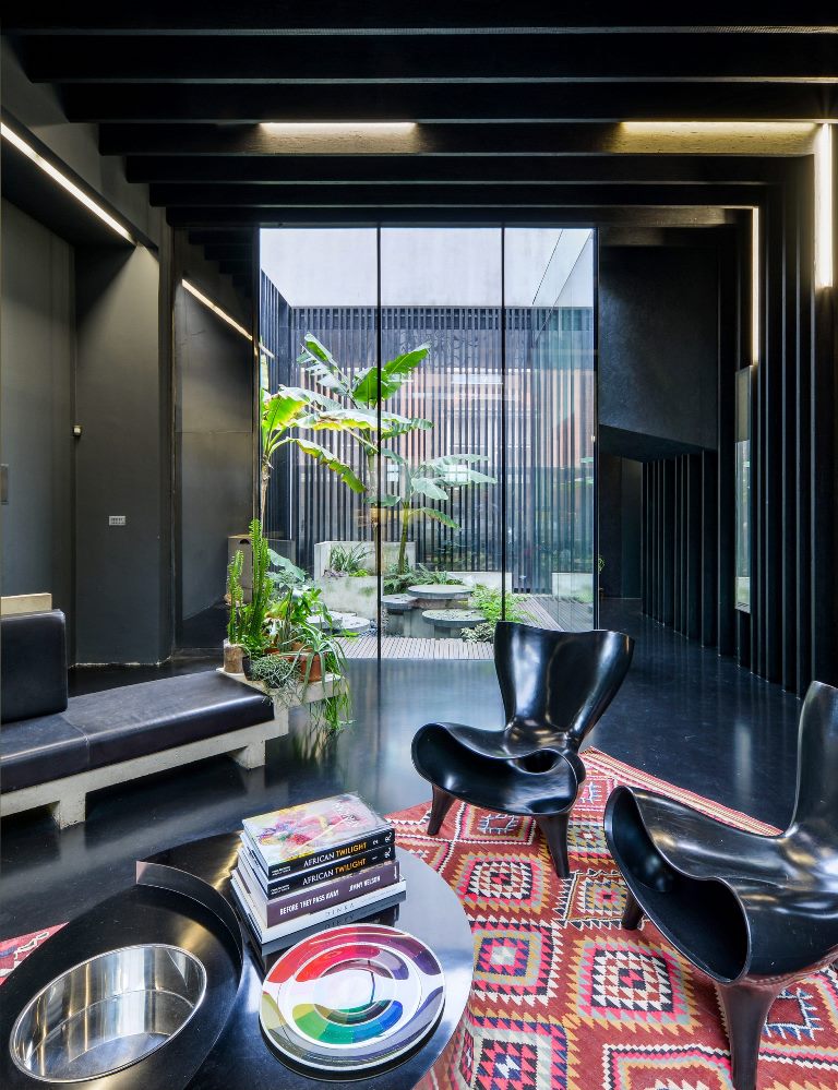 Though the interiors are black, they don't seem moody as there are lightwells and glazed walls