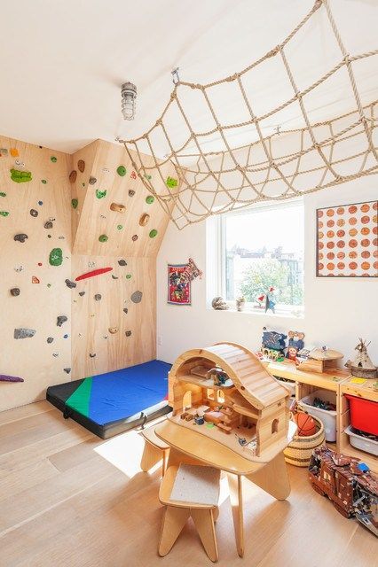 a fun and creative kids' playroom with a climbing wall, a net and many toys is a very bold idea to try