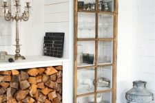 a built-in storage unit with a glass door made of old window frames is a stylish idea for a rustic space