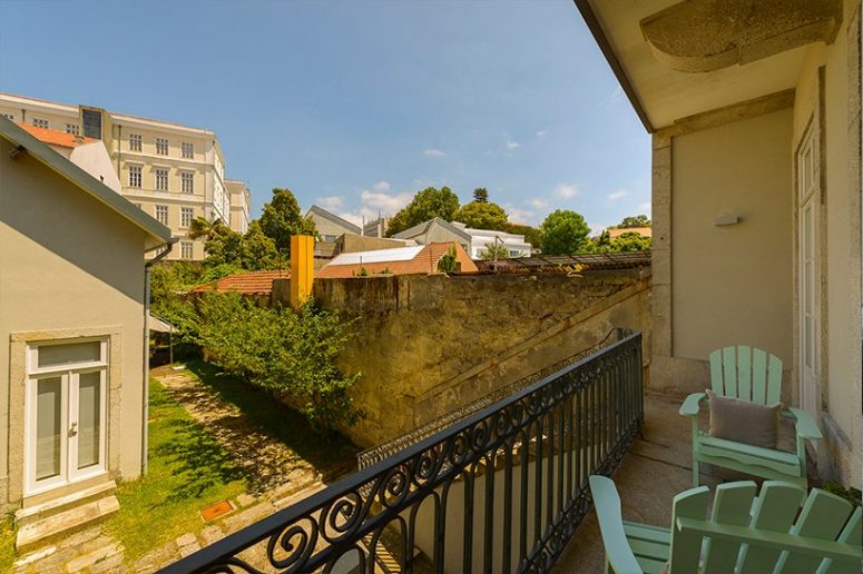 There's a small balcony that leads to a cozy and green inner courtyard and provides views