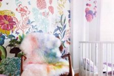 05 add a girlish accent to this nursery with bold floral wallpaper and support it with bedding or furniture covers