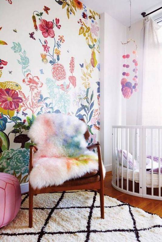 add a girlish accent to this nursery with bold floral wallpaper and support it with bedding or furniture covers