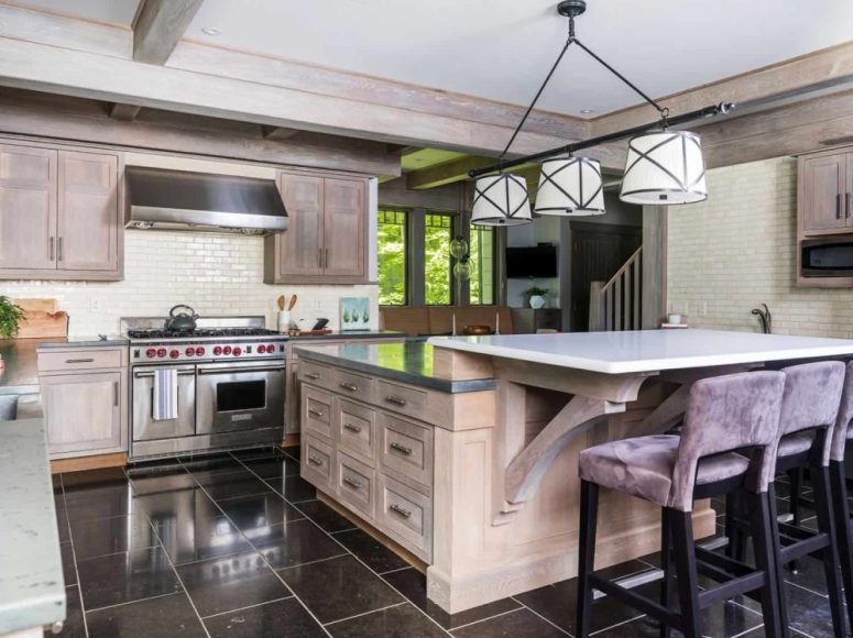 The kitchen is neutral, with farmhouse decor, whitewashed cabinetry and a pendant lamp